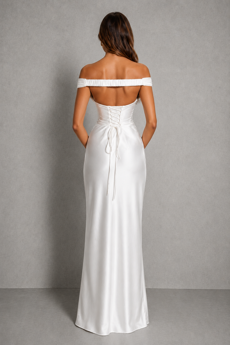 Woman wearing a white off-shoulder gown against a gray background