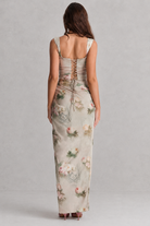 Woman wearing a floral dress with a gray background