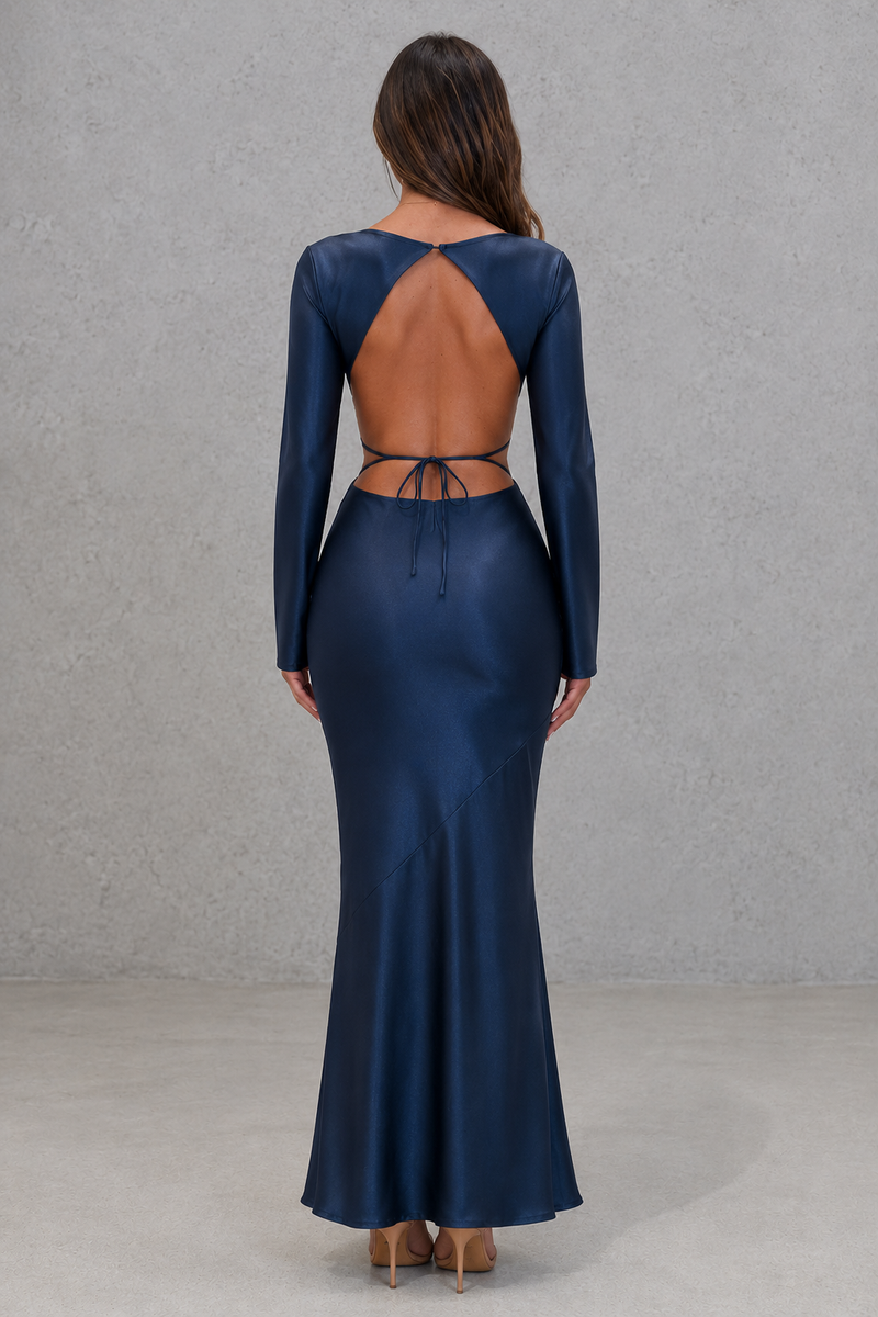 Navy blue long-sleeve gown with open back on a gray background