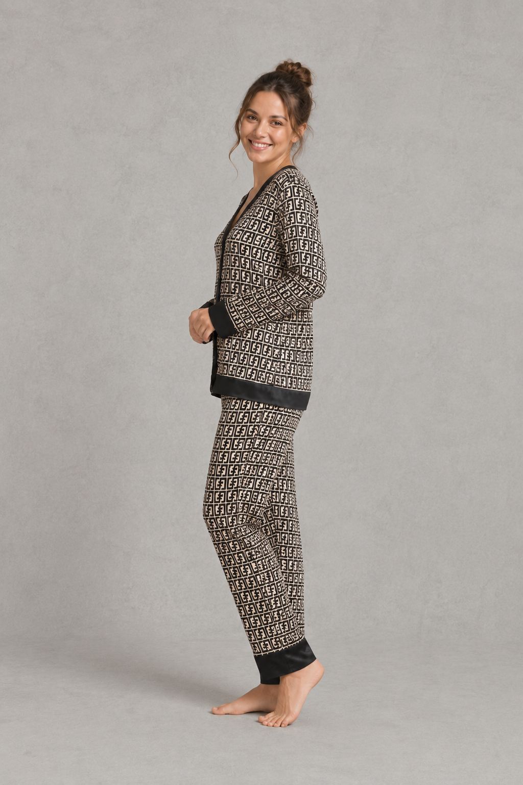 Women's brown satin two-piece pyjama set with a geometric print, long sleeve button-up V-neck top and matching full-length trousers.