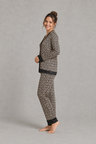 Women's brown satin two-piece pyjama set with a geometric print, long sleeve button-up V-neck top and matching full-length trousers.
