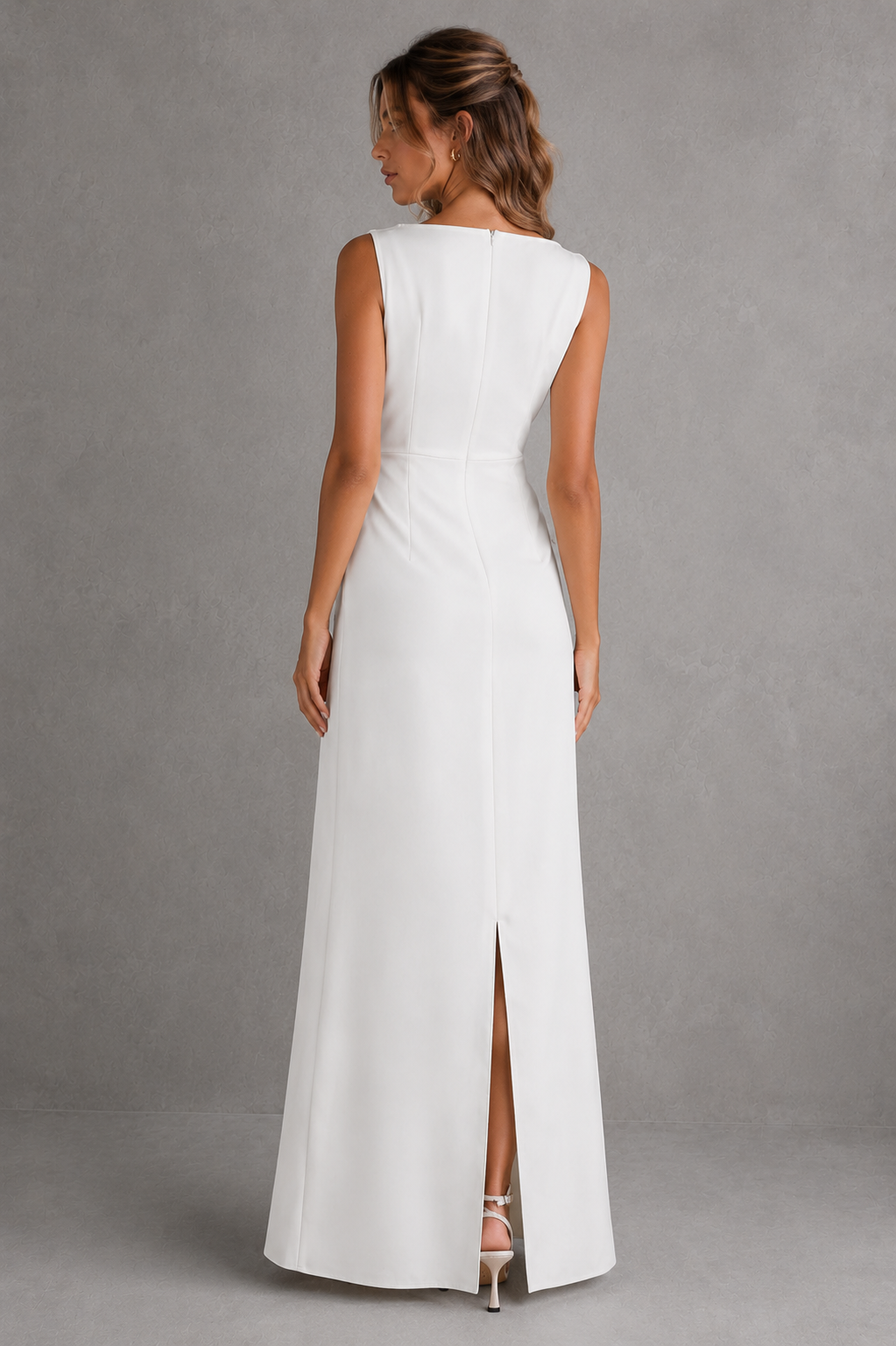 Woman wearing a white sleeveless dress with a slit on a gray background