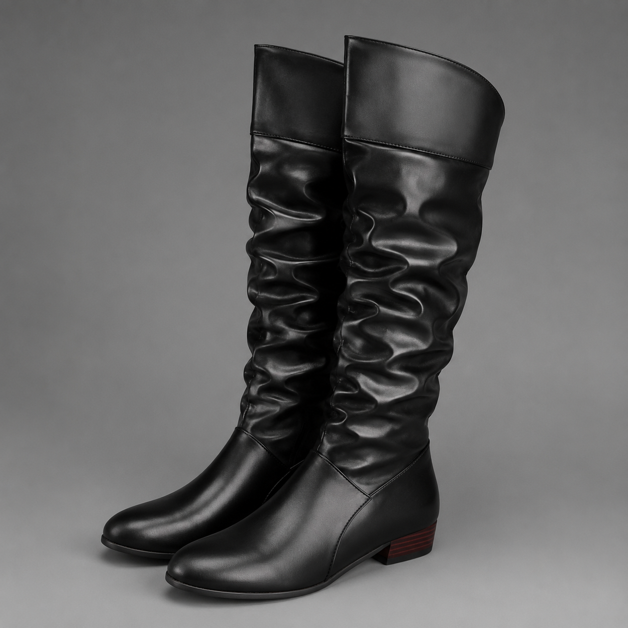 Women's black slouch knee-high boots with a low block heel, smooth PU leather upper, relaxed slouch design and durable rubber sole, ideal for everyday autumn and winter wear.