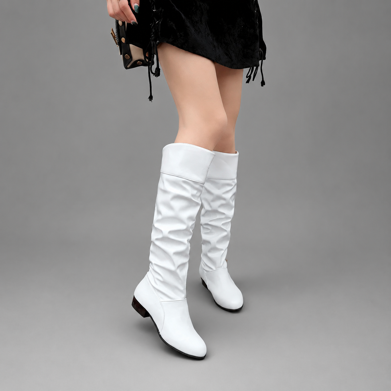 Women's black slouch knee-high boots with a low block heel, smooth PU leather upper, relaxed slouch design and durable rubber sole, ideal for everyday autumn and winter wear.