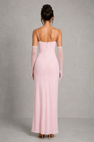 Pink evening gown with sheer sleeves on a gray background