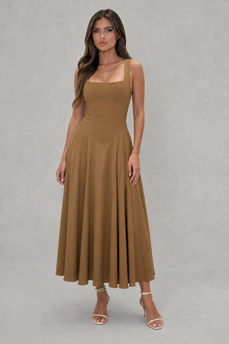 Woman wearing a brown dress against a gray background
