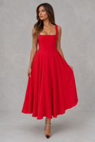 Woman wearing a red dress against a gray background