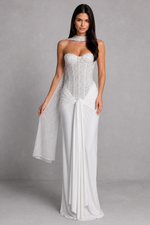 Woman wearing a strapless white gown with a gray background