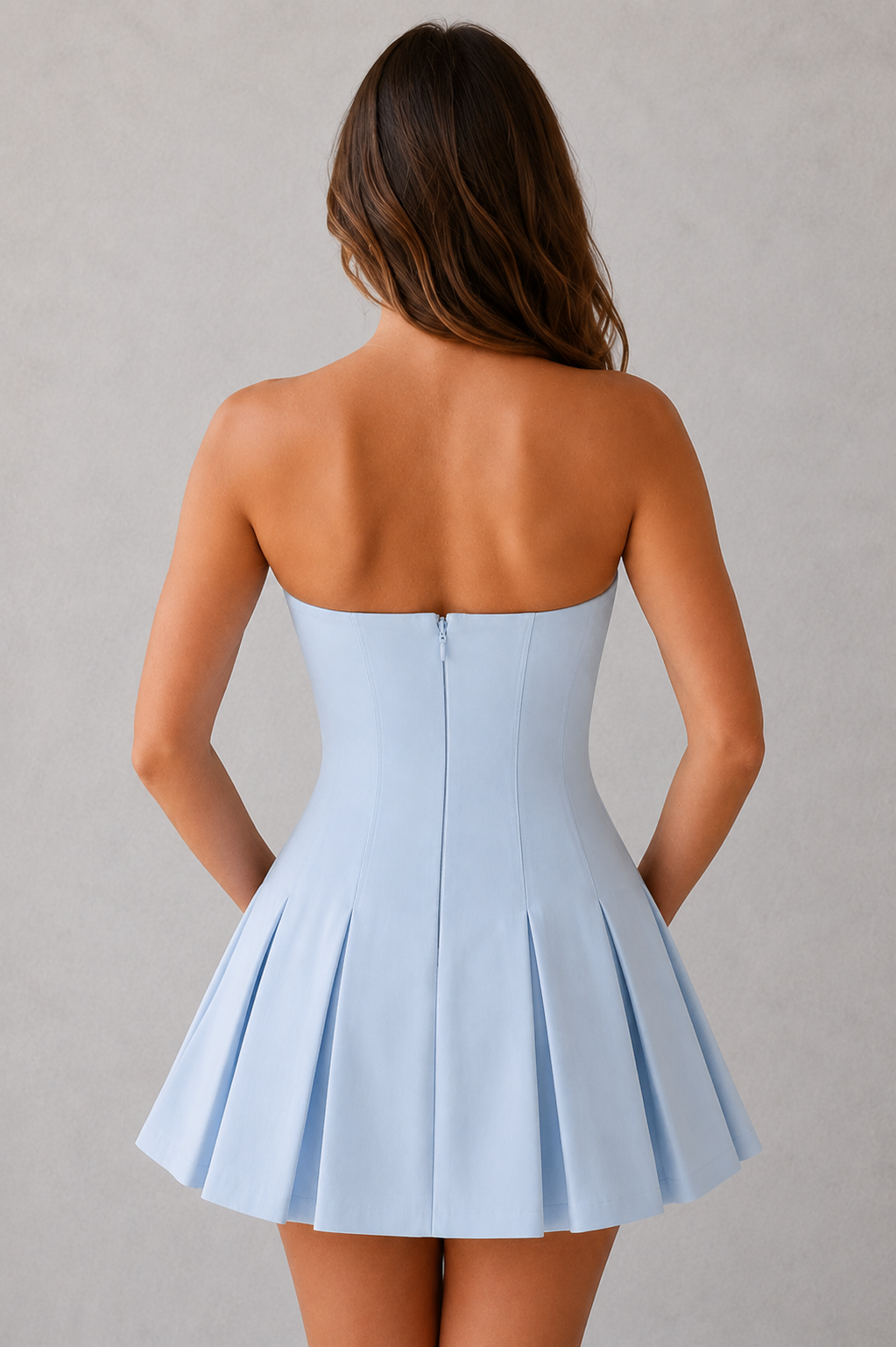 Light blue strapless dress worn by a person on a gray background