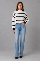 Women’s striped mock neck knit jumper with long sleeves, relaxed dropped shoulders and a cosy casual fit for autumn and winter.