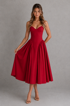 Woman wearing a red dress against a gray background