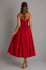 Red dress with thin straps on a gray background