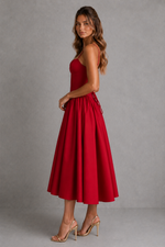 Woman wearing a red dress against a gray background