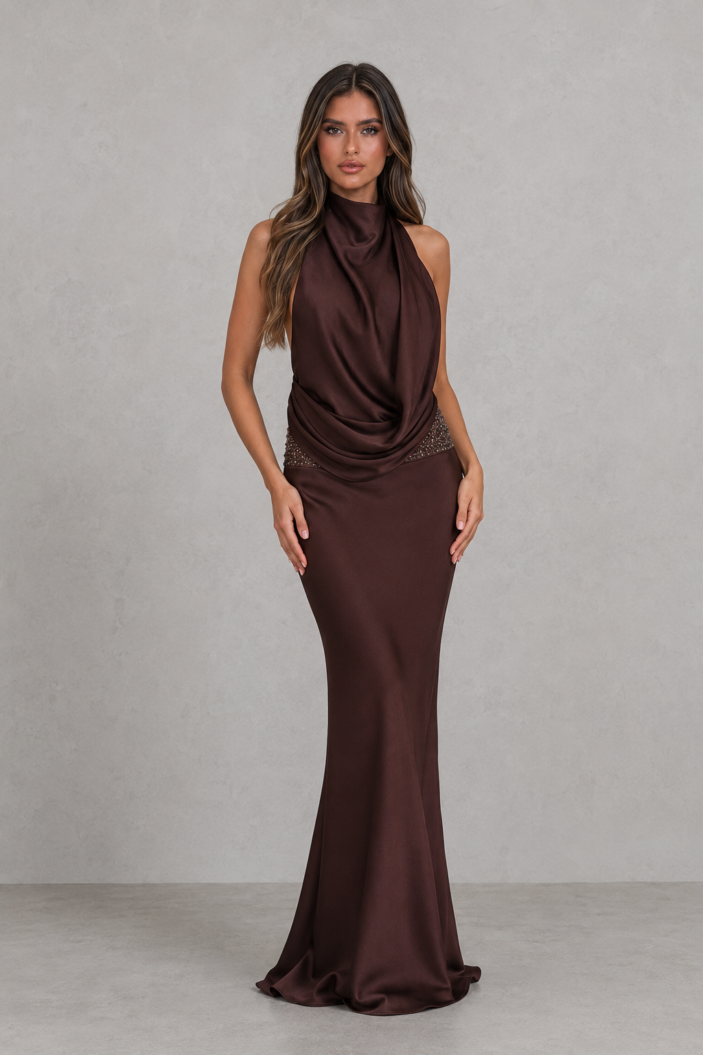 Woman wearing a brown evening gown against a plain background