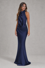 Navy blue evening gown on a model against a neutral background