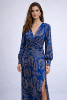 Woman wearing a blue patterned dress on a white background