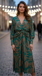Woman wearing a green patterned dress on a blurred street background