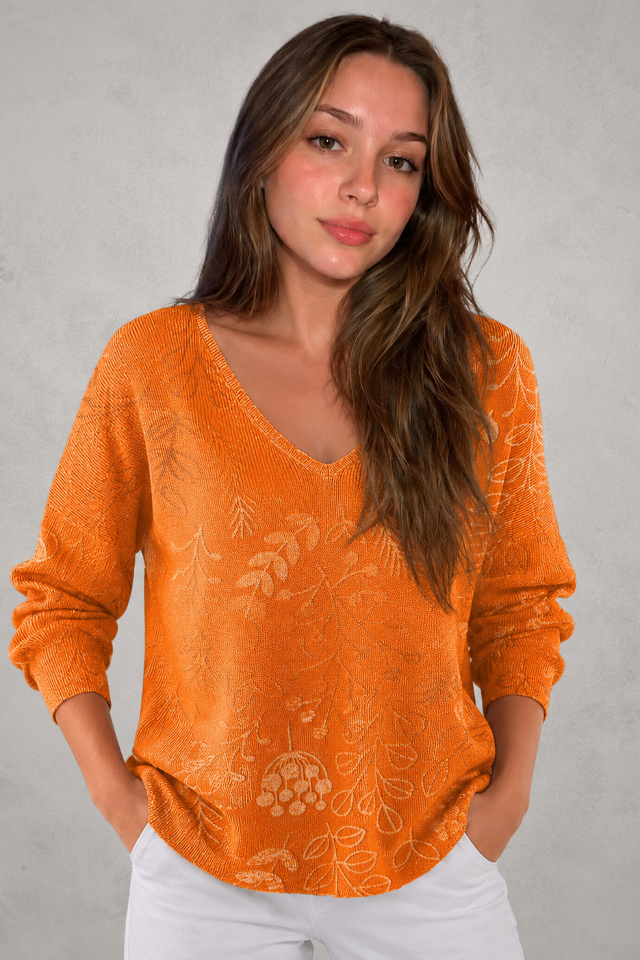 Woman wearing a patterned V-neck top with an autumn-inspired print, featuring a relaxed fit, lightweight breathable fabric, and long sleeves. Styled for casual everyday wear with a flattering feminine silhouette, suitable for pairing with jeans, trousers, skirts, or leggings.