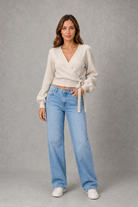 Women’s V-neck wrap knit jumper with long sleeves, crossover front and adjustable tie waist bow.