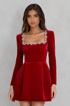 Red dress with silver embellishments on a gray background
