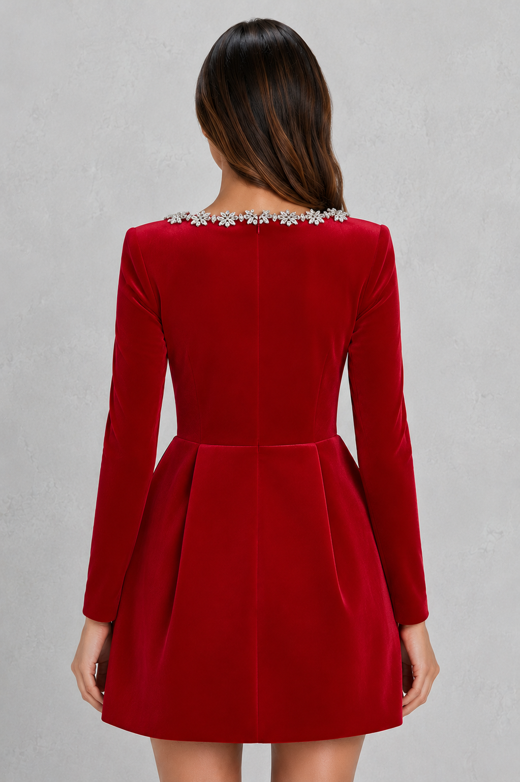 Red dress with long sleeves and embellished neckline on a gray background