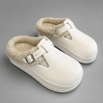 Women's waterproof fur-lined mule slippers with a thick non-slip sole, plush faux fur lining, metal buckle detail and lightweight slip-on design for warm indoor comfort during autumn and winter.