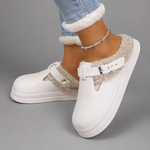 Women's waterproof fur-lined mule slippers with a thick non-slip sole, plush faux fur lining, metal buckle detail and lightweight slip-on design for warm indoor comfort during autumn and winter.
