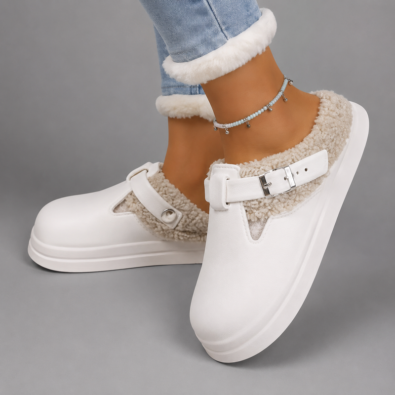 Women's waterproof fur-lined mule slippers with a thick non-slip sole, plush faux fur lining, metal buckle detail and lightweight slip-on design for warm indoor comfort during autumn and winter.