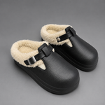 Women's waterproof fur-lined mule slippers with a thick non-slip sole, plush faux fur lining, metal buckle detail and lightweight slip-on design for warm indoor comfort during autumn and winter.