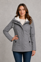 Women's waterproof hooded longline coat with a warm insulated lining, adjustable hood, and elegant longline design, offering reliable all-weather protection for everyday wear, commuting, travel, and outdoor walks.