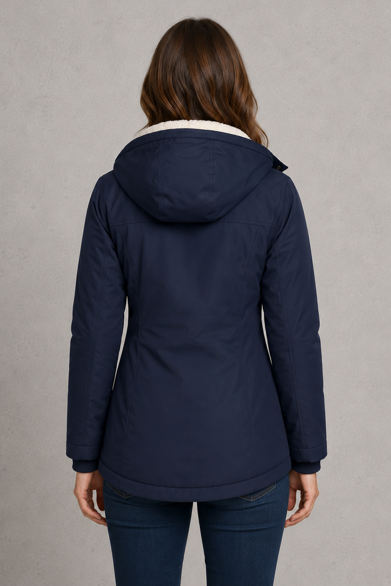 Women's waterproof hooded longline coat with a warm insulated lining, adjustable hood, and elegant longline design, offering reliable all-weather protection for everyday wear, commuting, travel, and outdoor walks.