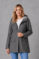 Women's waterproof and windproof hooded coat in a lightweight longline design with adjustable hood, weather-resistant fabric and a flattering regular fit, ideal for everyday wear, commuting and rainy British weather.