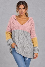 Women's pink multicolour chunky cable knit hooded jumper in pink, grey and mustard colour block – front view