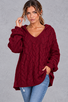 Women's burgundy chunky cable knit hooded jumper with V-neck – front view