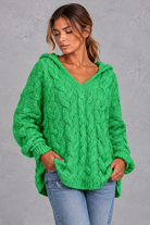 Women's green chunky cable knit hooded jumper with V-neck – front view