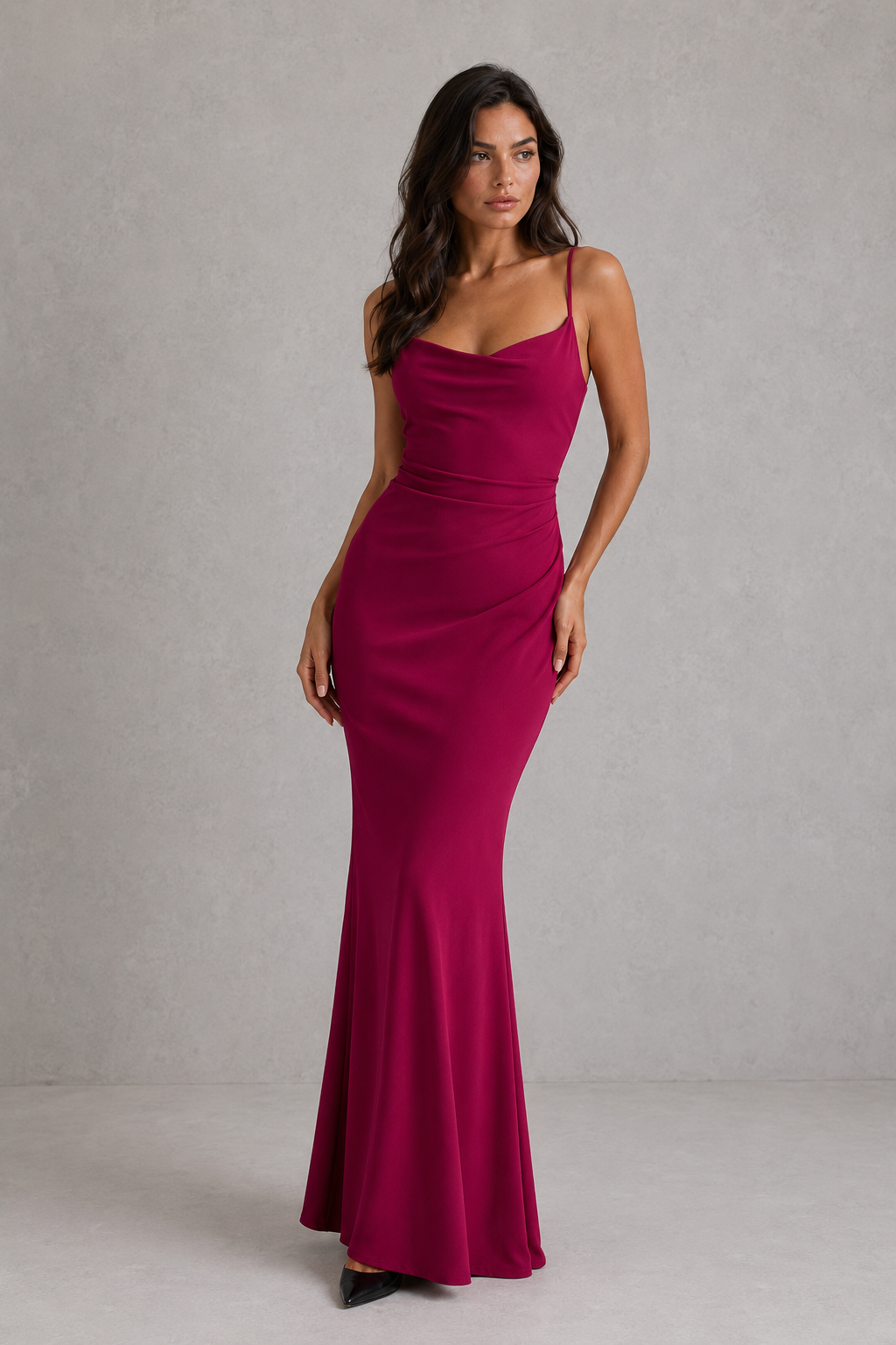 Woman wearing a magenta evening gown against a neutral background