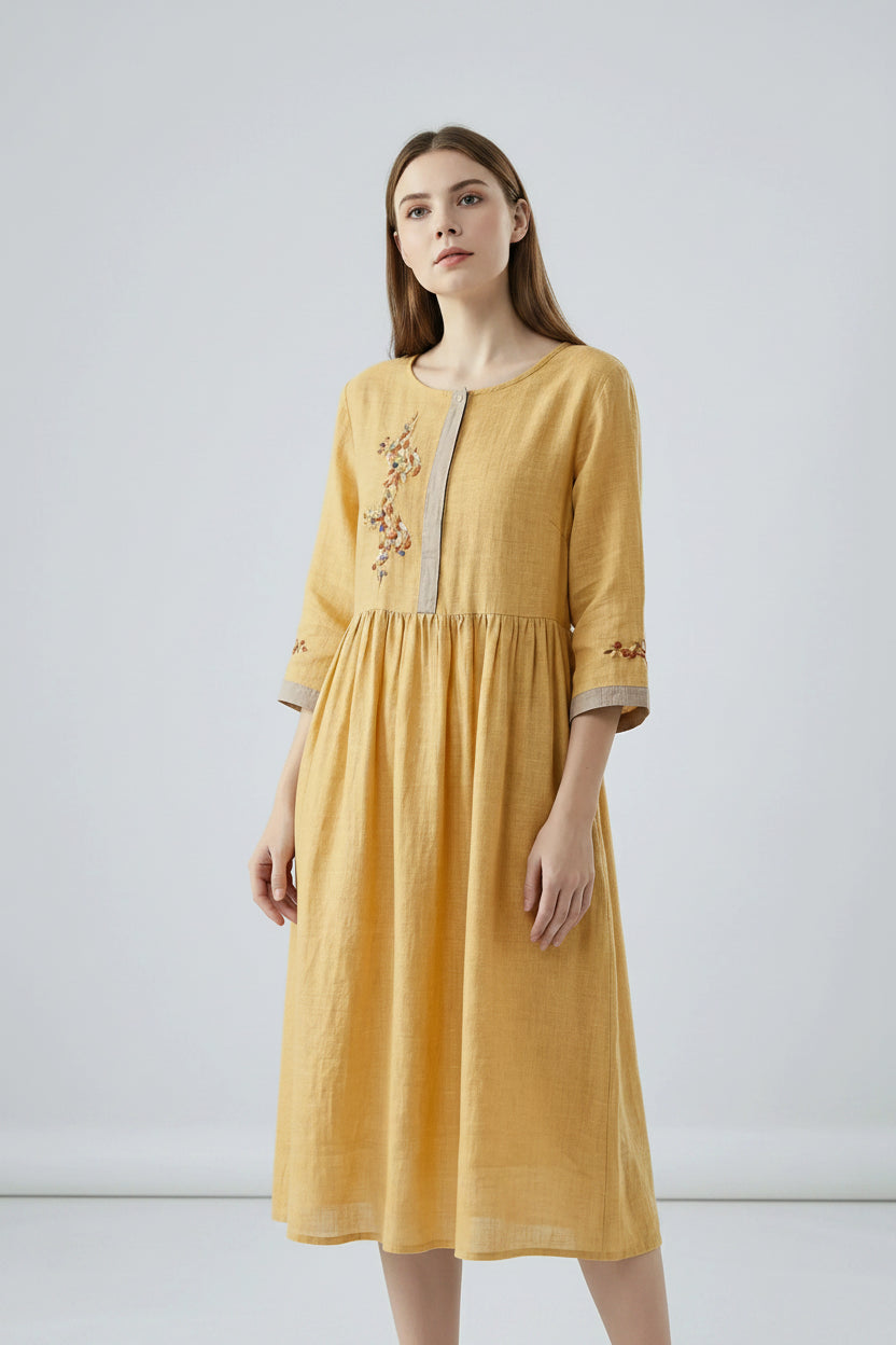 Yellow dress with embroidery on a white background