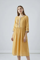 Yellow dress with embroidery on a white background