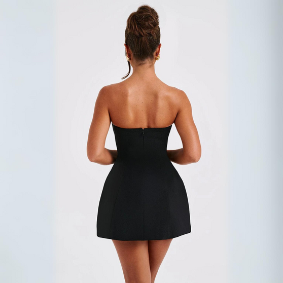 Woman wearing a black strapless dress on a white background