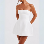 White strapless dress worn by a model on a white background