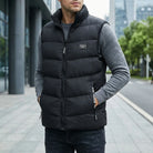 Man wearing a black puffer vest with a cityscape background