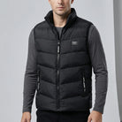 Man wearing a black puffer vest over a gray shirt on a light gray background1