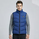 Man wearing a blue puffer vest on a light gray background