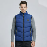 Man wearing a blue puffer vest on a light gray background