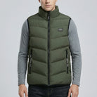 Person wearing a green puffer vest over a gray shirt on a light gray background