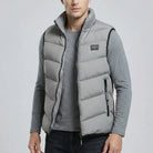 Man wearing a grey puffer vest on a light gray background