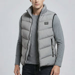 Man wearing a grey puffer vest on a light gray background