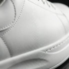 Close-up of a white leather shoe with visible stitching2