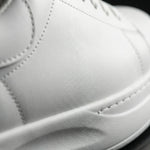 Close-up of a white leather shoe with visible stitching2