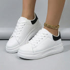 Women’s low-top white sneakers with cushioned sole and lace-up closure for comfortable all-day wear, available in white and white/black.
